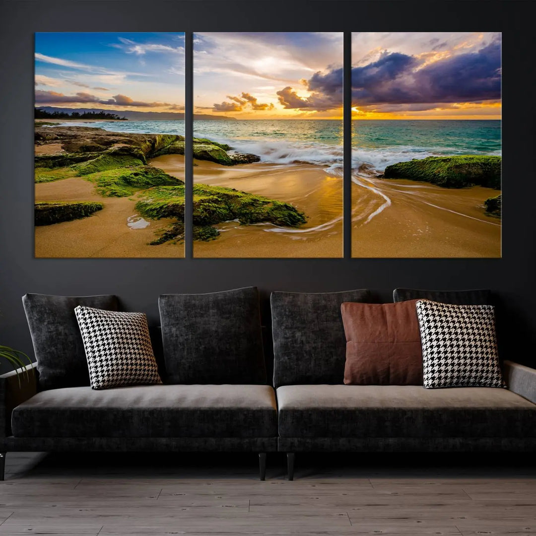 The Sunset Beach Wall Art Canvas Print is a gallery-wrapped triptych showcasing a beach scene with mossy rocks and a vibrant sunset. Made from museum-quality canvas and featuring a UV-protective coating, it elegantly provides both beauty and durability.