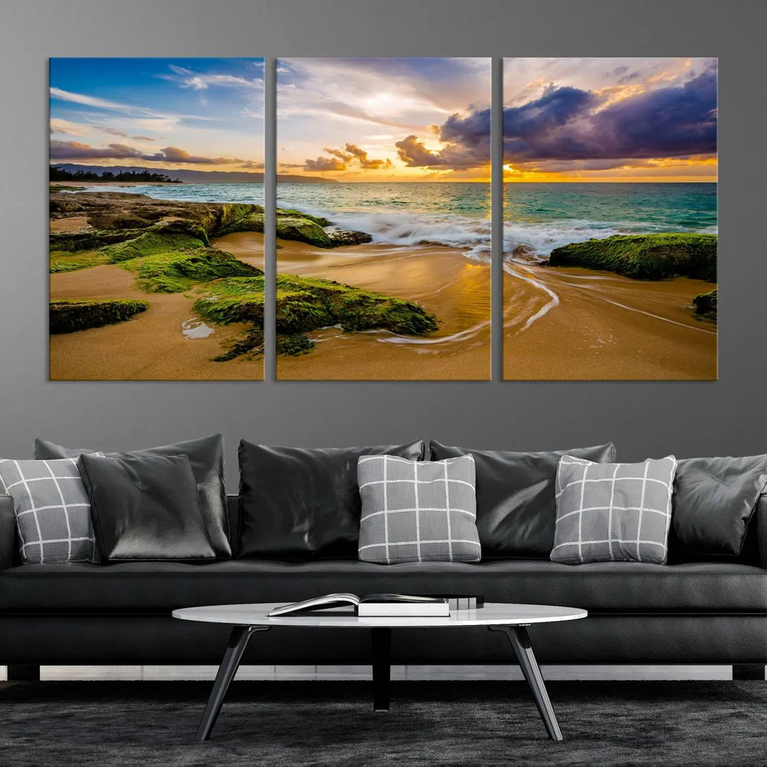 The Sunset Beach Wall Art Canvas Print is a gallery-wrapped triptych showcasing a beach scene with mossy rocks and a vibrant sunset. Made from museum-quality canvas and featuring a UV-protective coating, it elegantly provides both beauty and durability.