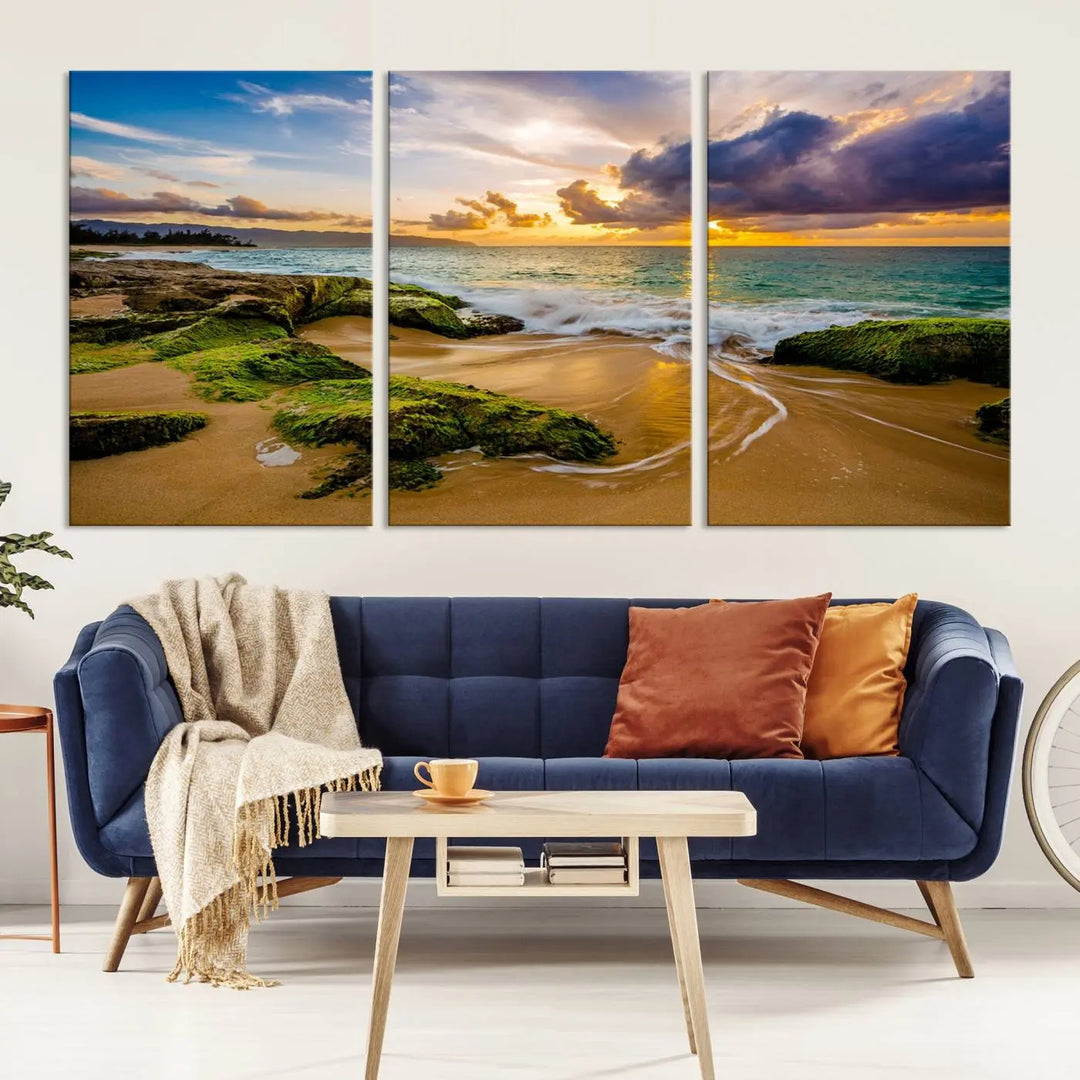 The Sunset Beach Wall Art Canvas Print is a gallery-wrapped triptych showcasing a beach scene with mossy rocks and a vibrant sunset. Made from museum-quality canvas and featuring a UV-protective coating, it elegantly provides both beauty and durability.