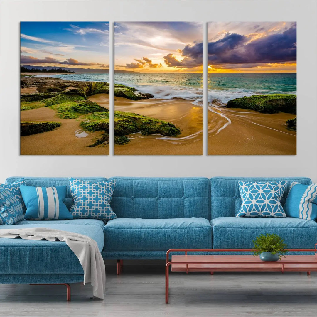 The Sunset Beach Wall Art Canvas Print is a gallery-wrapped triptych showcasing a beach scene with mossy rocks and a vibrant sunset. Made from museum-quality canvas and featuring a UV-protective coating, it elegantly provides both beauty and durability.