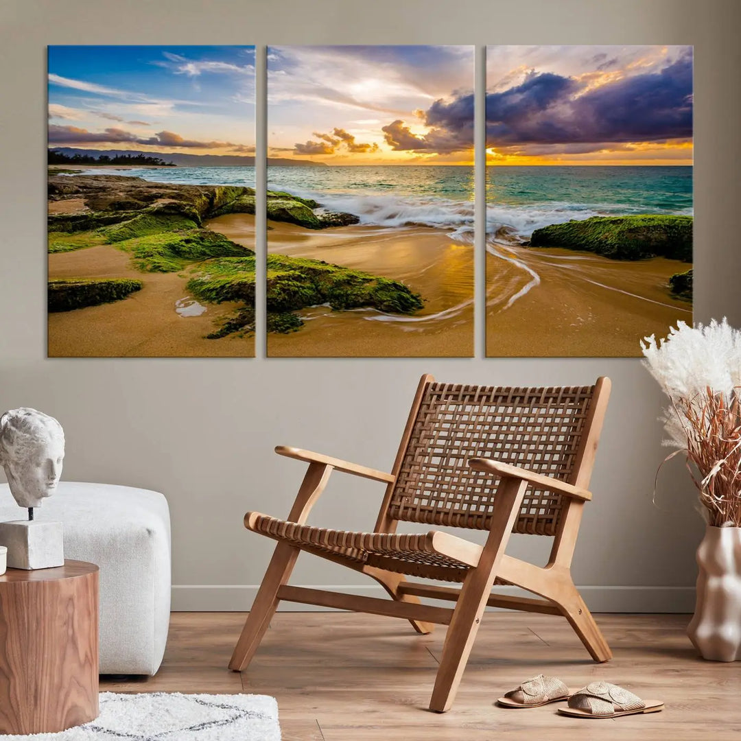 The Sunset Beach Wall Art Canvas Print is a gallery-wrapped triptych showcasing a beach scene with mossy rocks and a vibrant sunset. Made from museum-quality canvas and featuring a UV-protective coating, it elegantly provides both beauty and durability.