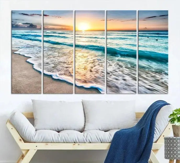 The living room features the Sunset Beach Waves Canvas Wall Art—an ocean sunset print spread over five panels that enhance your space with coastal decor. Cozy, nature-themed elements add warmth and charm to the ambiance.