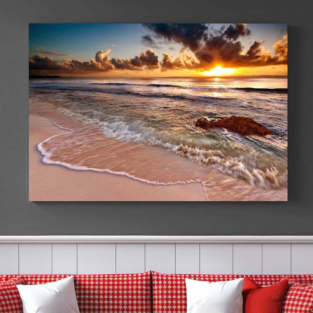 The Sunset Beach Waves Triptych Wall Art, featuring a tropical ocean scene on giclee canvas with a gallery wrap, adorns the wall in a cozy, coastal-themed living room.