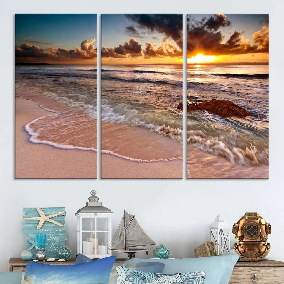 The Sunset Beach Waves Triptych Wall Art, featuring a tropical ocean scene on giclee canvas with a gallery wrap, adorns the wall in a cozy, coastal-themed living room.