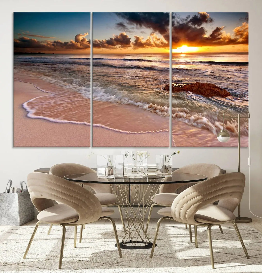 The Sunset Beach Waves Triptych Wall Art, featuring a tropical ocean scene on giclee canvas with a gallery wrap, adorns the wall in a cozy, coastal-themed living room.