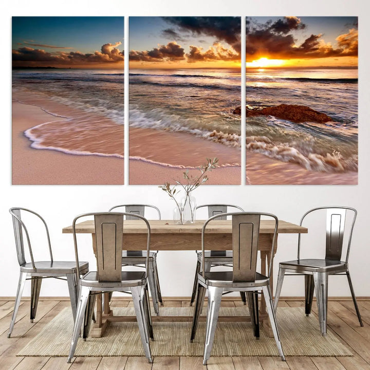 The Sunset Beach Waves Triptych Wall Art, featuring a tropical ocean scene on giclee canvas with a gallery wrap, adorns the wall in a cozy, coastal-themed living room.