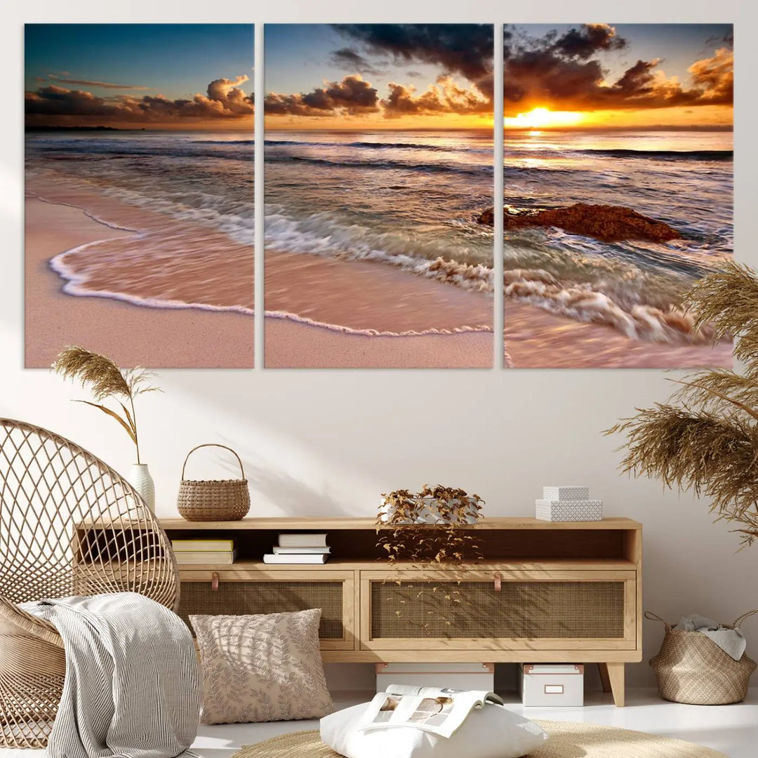 The Sunset Beach Waves Triptych Wall Art, featuring a tropical ocean scene on giclee canvas with a gallery wrap, adorns the wall in a cozy, coastal-themed living room.