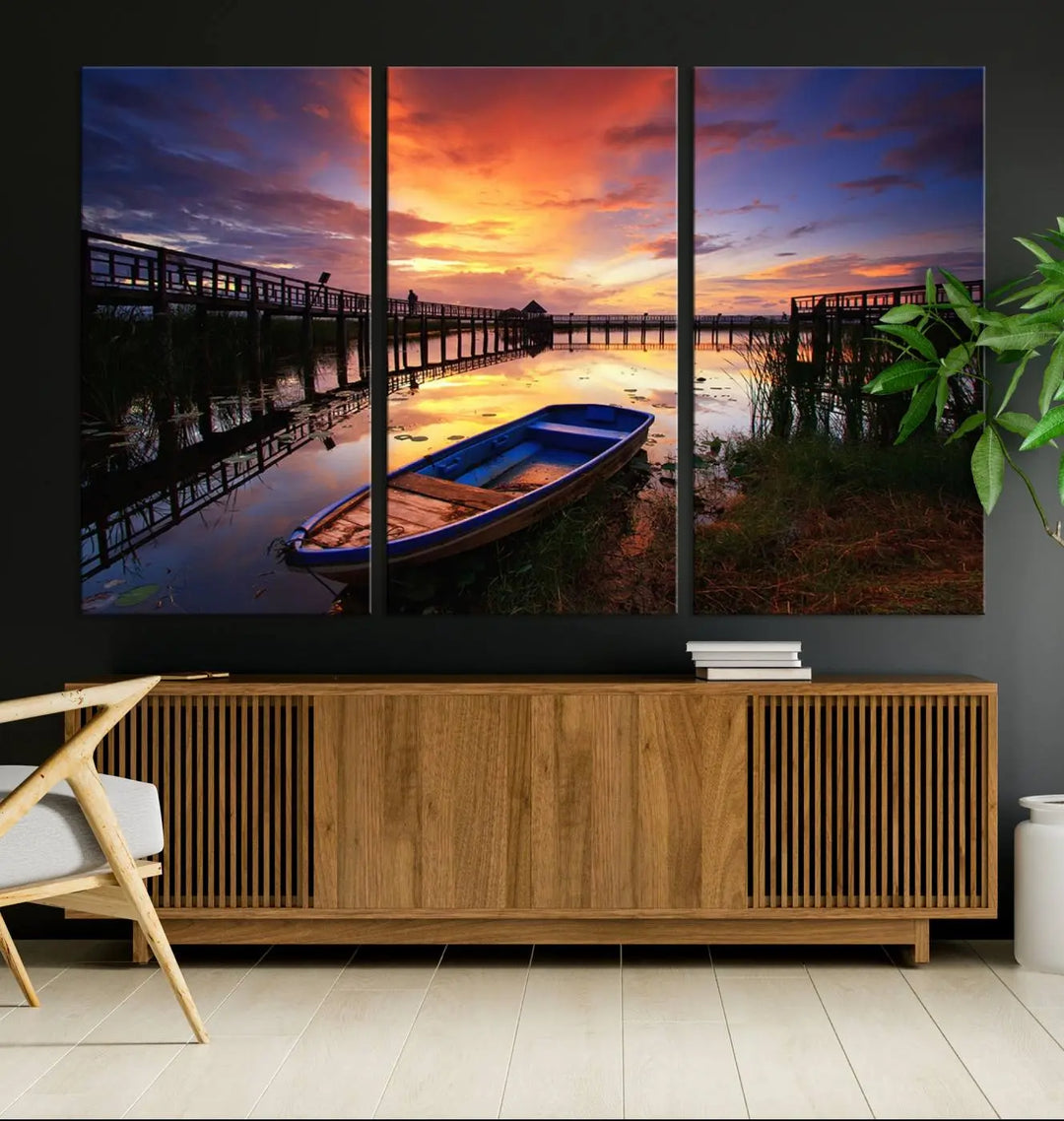 The "Sunset Boat Scene on Lake Triptych" beautifully captures a vibrant sunset over a calm lake. This tranquil scene, featuring serene reflections and surrounded by reeds, is printed on premium giclee canvas with Canon print quality. The gallery wrap design enhances every detail of tranquility.