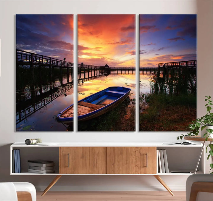 The "Sunset Boat Scene on Lake Triptych" beautifully captures a vibrant sunset over a calm lake. This tranquil scene, featuring serene reflections and surrounded by reeds, is printed on premium giclee canvas with Canon print quality. The gallery wrap design enhances every detail of tranquility.