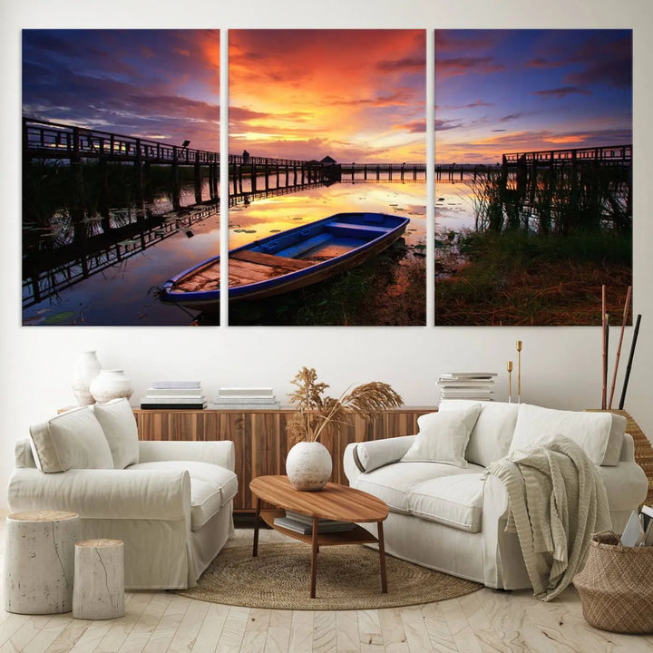 The "Sunset Boat Scene on Lake Triptych" beautifully captures a vibrant sunset over a calm lake. This tranquil scene, featuring serene reflections and surrounded by reeds, is printed on premium giclee canvas with Canon print quality. The gallery wrap design enhances every detail of tranquility.