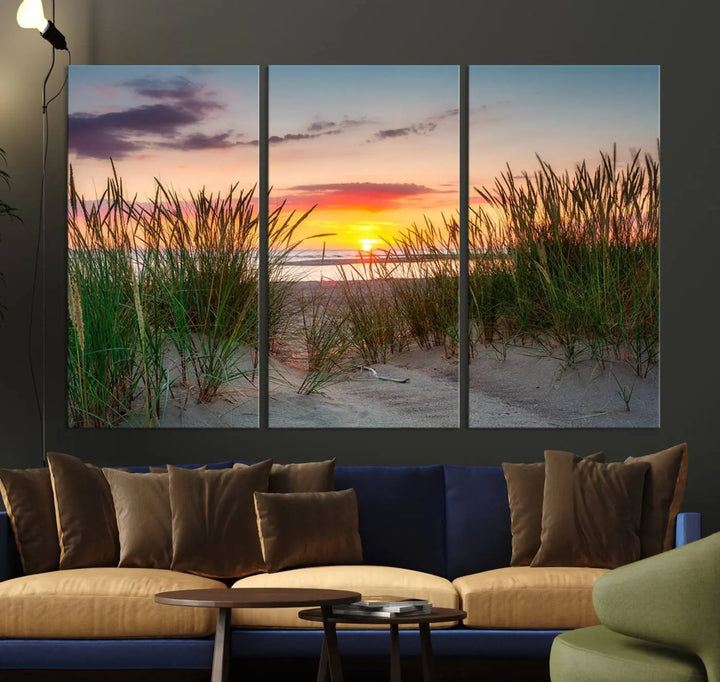 A set of three "Sunset Coastal Beach Wall Art Canvas Prints," featuring a beach sunset with tall grasses, gallery wrapped on museum-quality canvases.