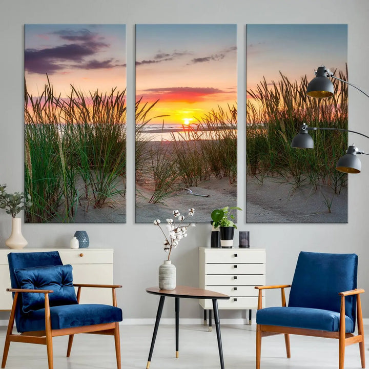 A set of three "Sunset Coastal Beach Wall Art Canvas Prints," featuring a beach sunset with tall grasses, gallery wrapped on museum-quality canvases.