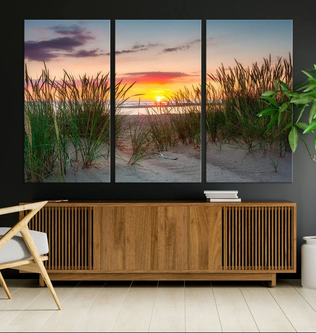 A set of three "Sunset Coastal Beach Wall Art Canvas Prints," featuring a beach sunset with tall grasses, gallery wrapped on museum-quality canvases.