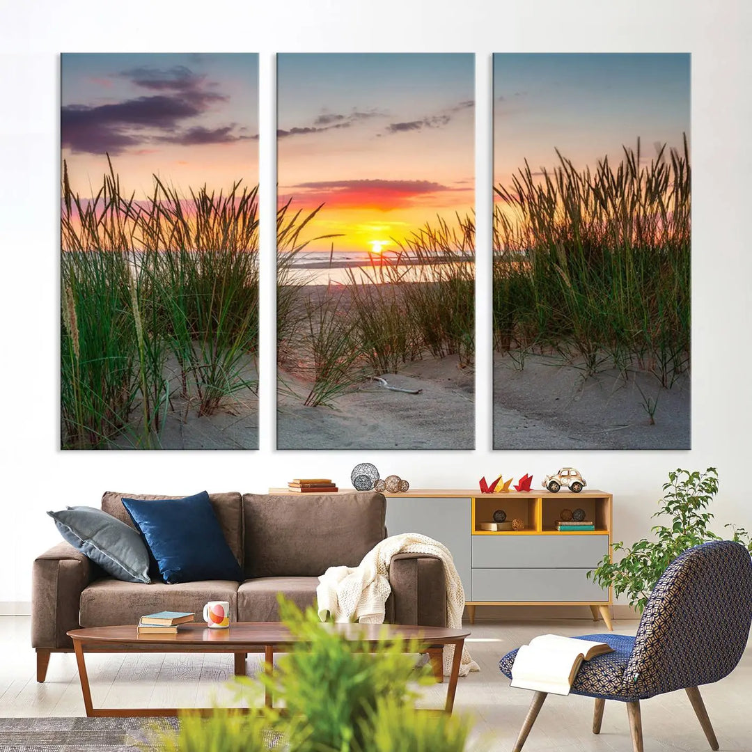 A set of three "Sunset Coastal Beach Wall Art Canvas Prints," featuring a beach sunset with tall grasses, gallery wrapped on museum-quality canvases.