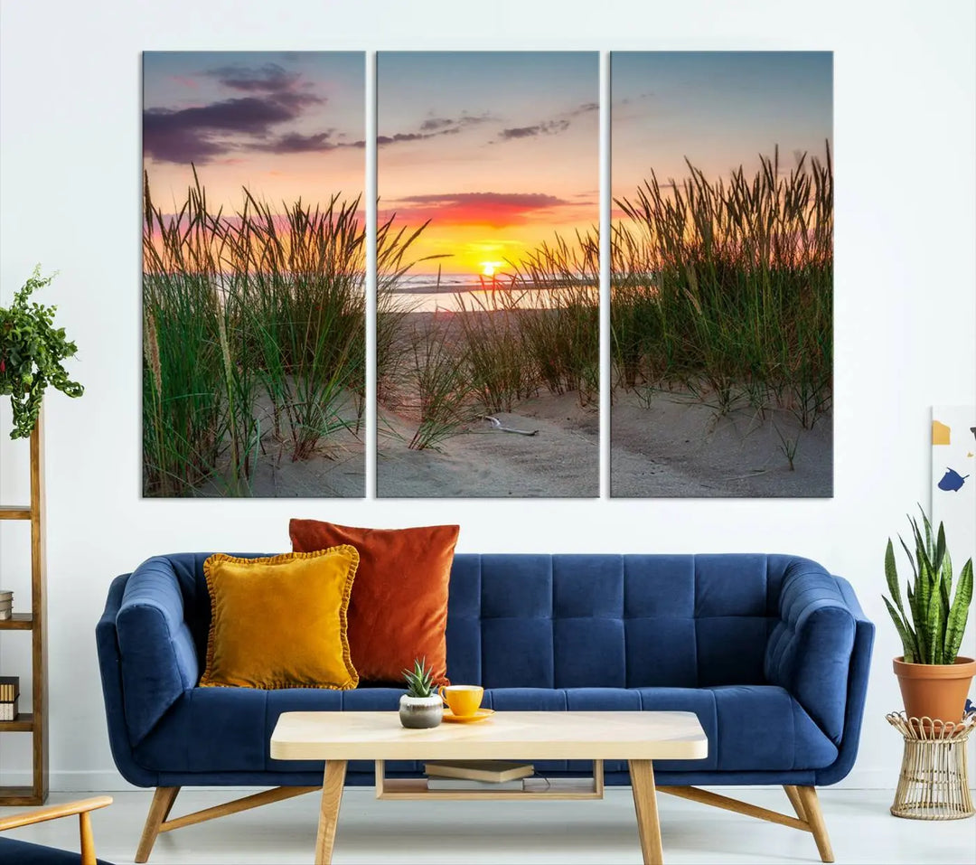 A set of three "Sunset Coastal Beach Wall Art Canvas Prints," featuring a beach sunset with tall grasses, gallery wrapped on museum-quality canvases.