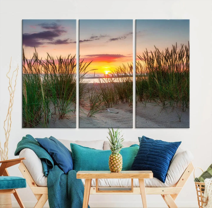 A set of three "Sunset Coastal Beach Wall Art Canvas Prints," featuring a beach sunset with tall grasses, gallery wrapped on museum-quality canvases.