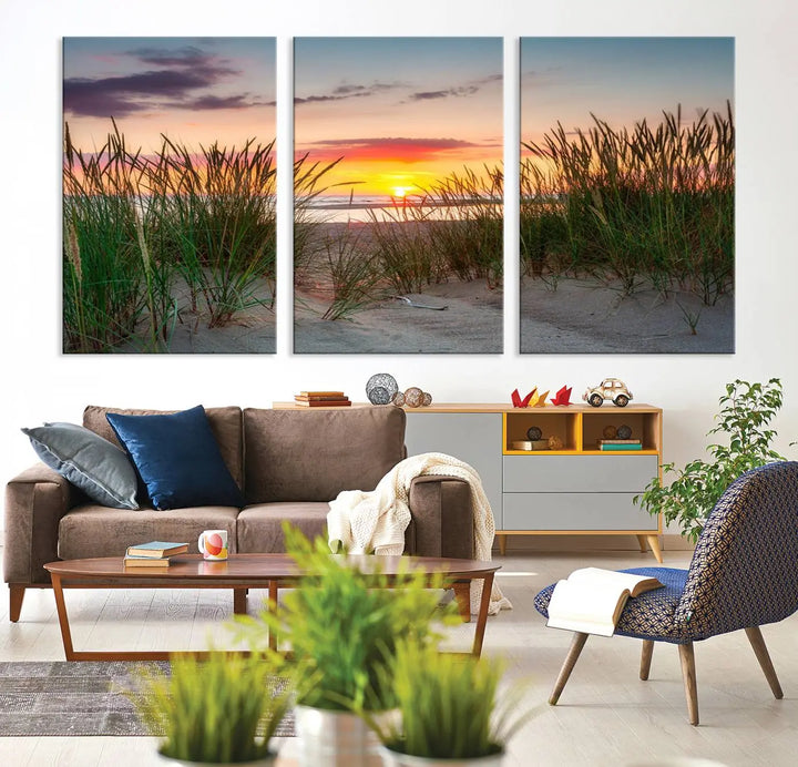 A set of three "Sunset Coastal Beach Wall Art Canvas Prints," featuring a beach sunset with tall grasses, gallery wrapped on museum-quality canvases.