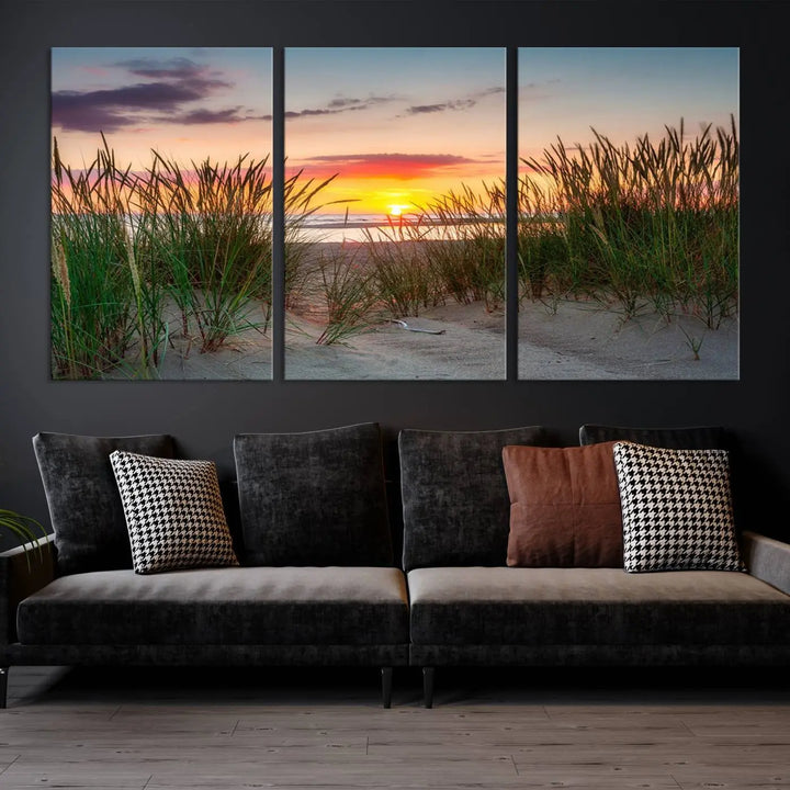 A set of three "Sunset Coastal Beach Wall Art Canvas Prints," featuring a beach sunset with tall grasses, gallery wrapped on museum-quality canvases.