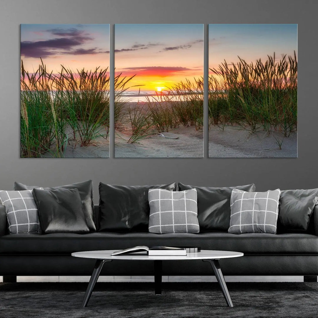 A set of three "Sunset Coastal Beach Wall Art Canvas Prints," featuring a beach sunset with tall grasses, gallery wrapped on museum-quality canvases.