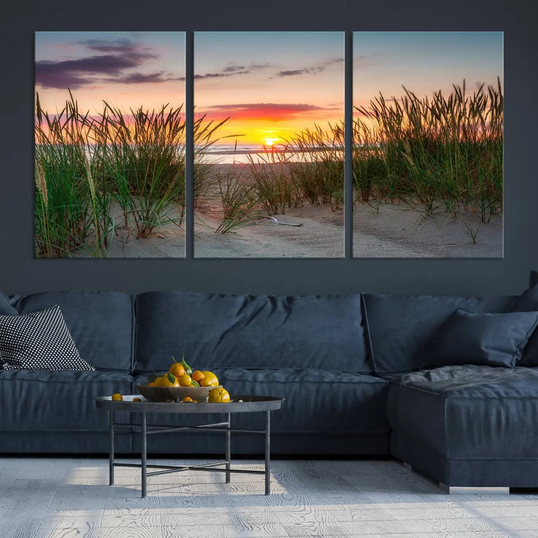 A set of three "Sunset Coastal Beach Wall Art Canvas Prints," featuring a beach sunset with tall grasses, gallery wrapped on museum-quality canvases.