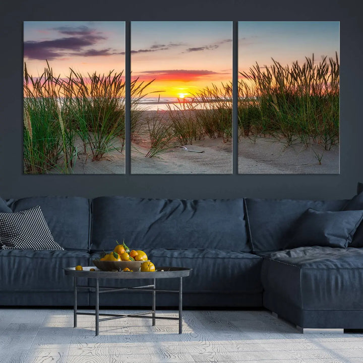 A set of three "Sunset Coastal Beach Wall Art Canvas Prints," featuring a beach sunset with tall grasses, gallery wrapped on museum-quality canvases.