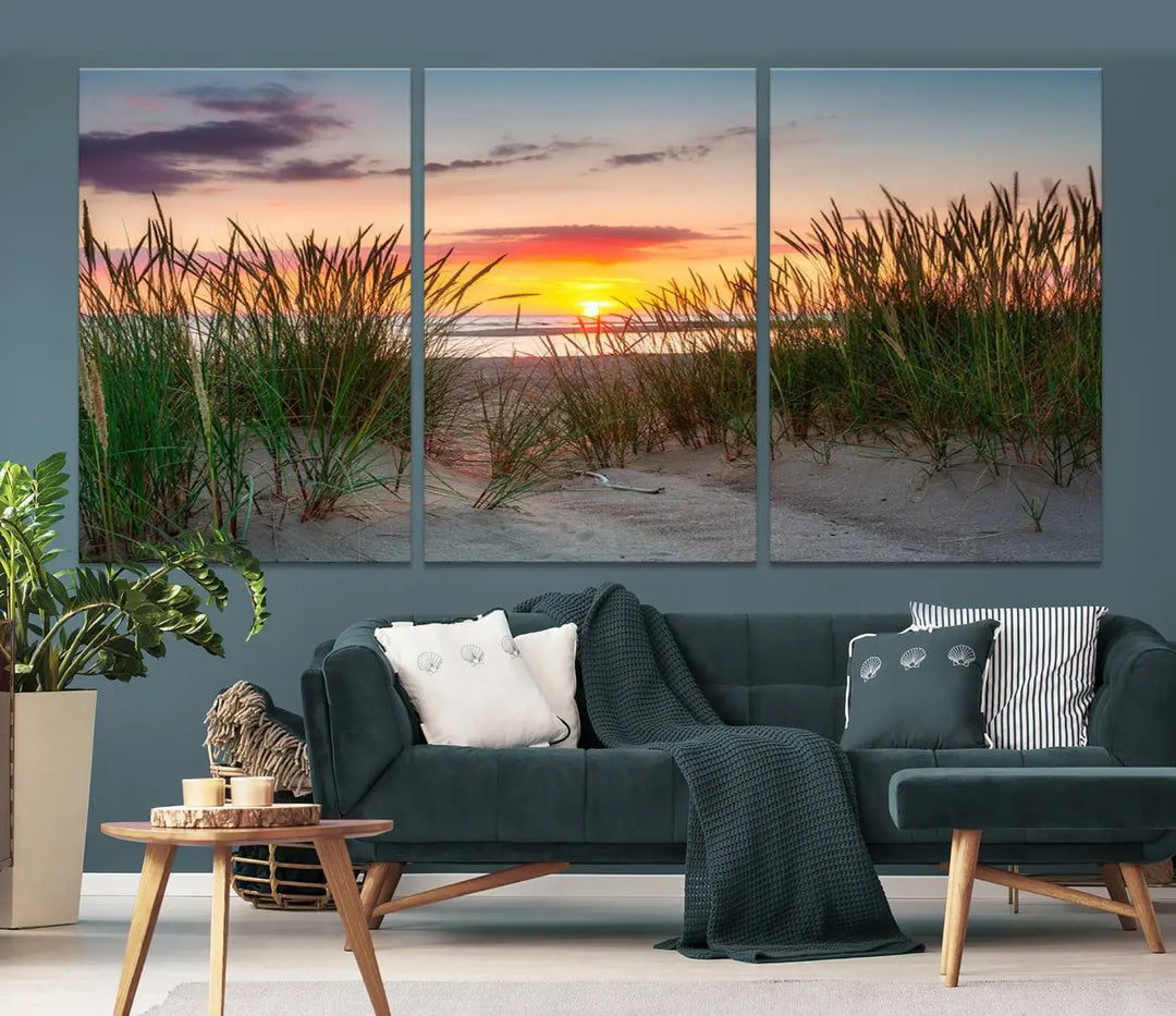 A set of three "Sunset Coastal Beach Wall Art Canvas Prints," featuring a beach sunset with tall grasses, gallery wrapped on museum-quality canvases.