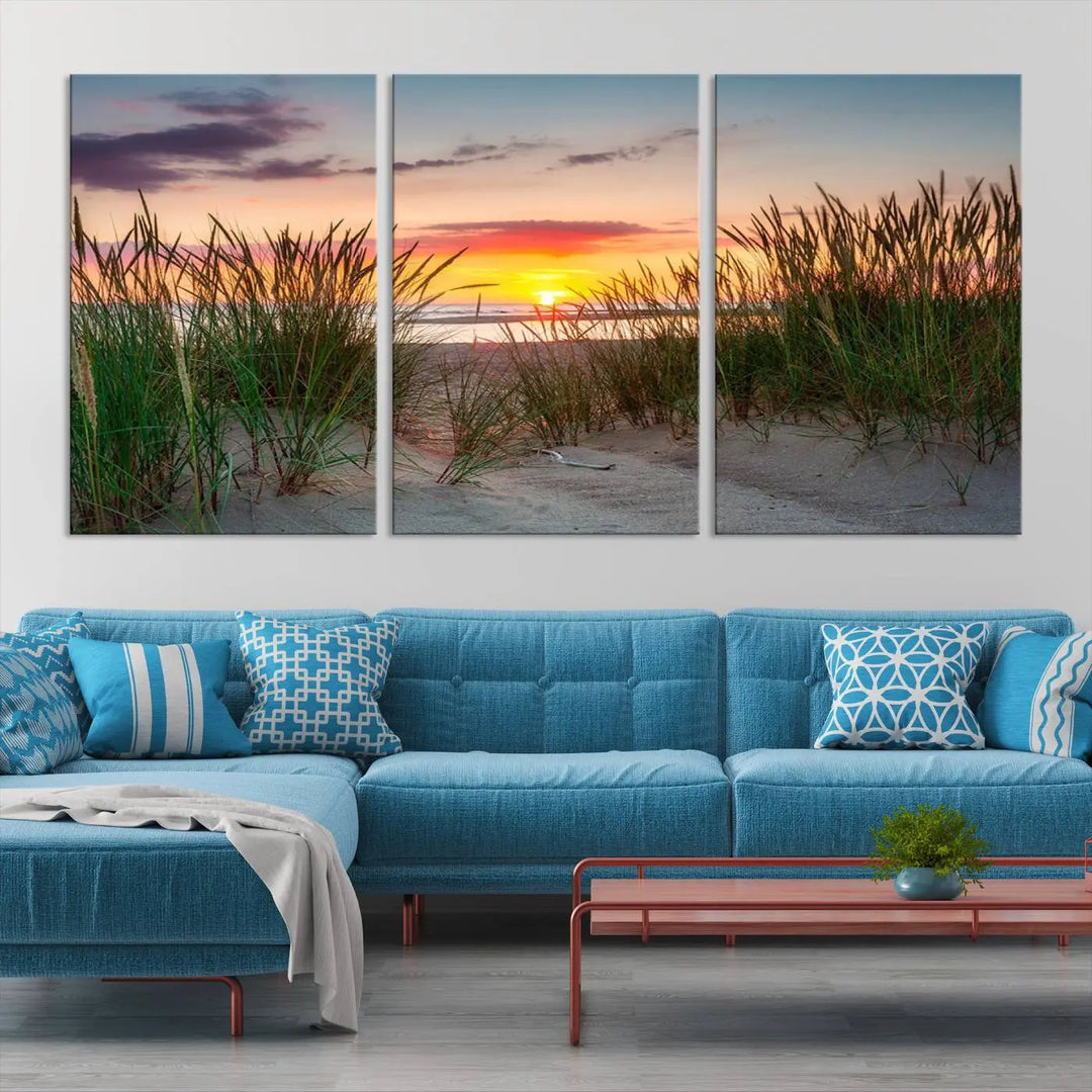 A set of three "Sunset Coastal Beach Wall Art Canvas Prints," featuring a beach sunset with tall grasses, gallery wrapped on museum-quality canvases.