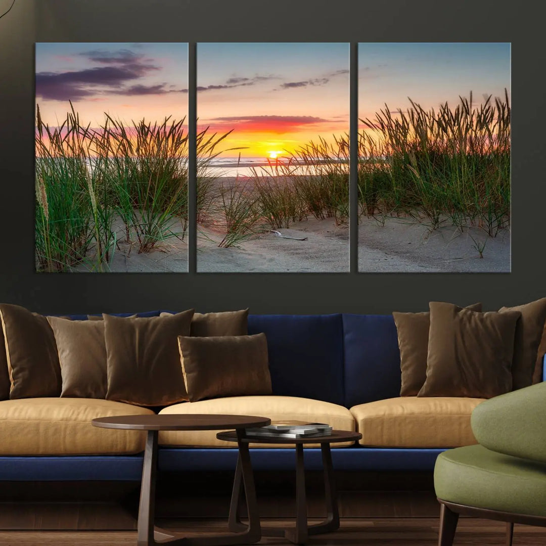 A set of three "Sunset Coastal Beach Wall Art Canvas Prints," featuring a beach sunset with tall grasses, gallery wrapped on museum-quality canvases.