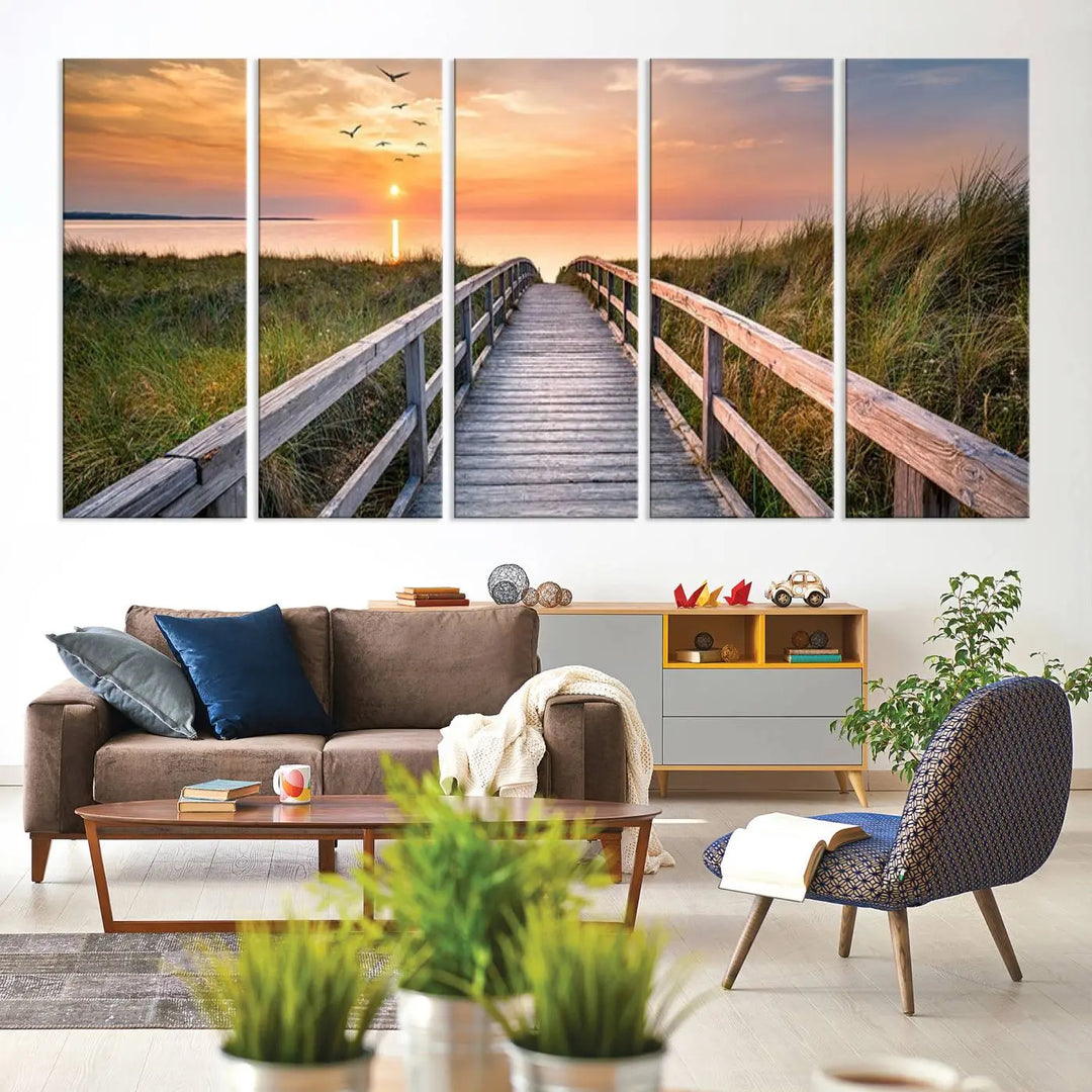 The Sunset Lakeside Pier Wall Art Canvas Print depicts a boardwalk leading towards a sunset over the ocean, framed by grassy dunes. Each piece is meticulously hand-assembled using museum-quality canvas to guarantee durability and vibrant colors.