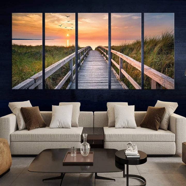 The Sunset Lakeside Pier Wall Art Canvas Print depicts a boardwalk leading towards a sunset over the ocean, framed by grassy dunes. Each piece is meticulously hand-assembled using museum-quality canvas to guarantee durability and vibrant colors.