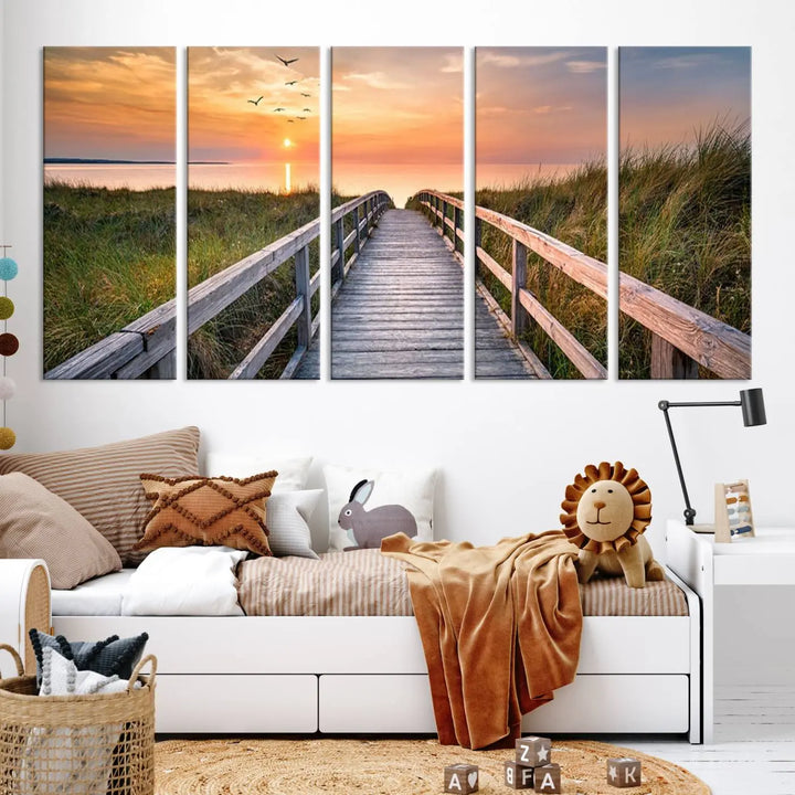 The Sunset Lakeside Pier Wall Art Canvas Print depicts a boardwalk leading towards a sunset over the ocean, framed by grassy dunes. Each piece is meticulously hand-assembled using museum-quality canvas to guarantee durability and vibrant colors.