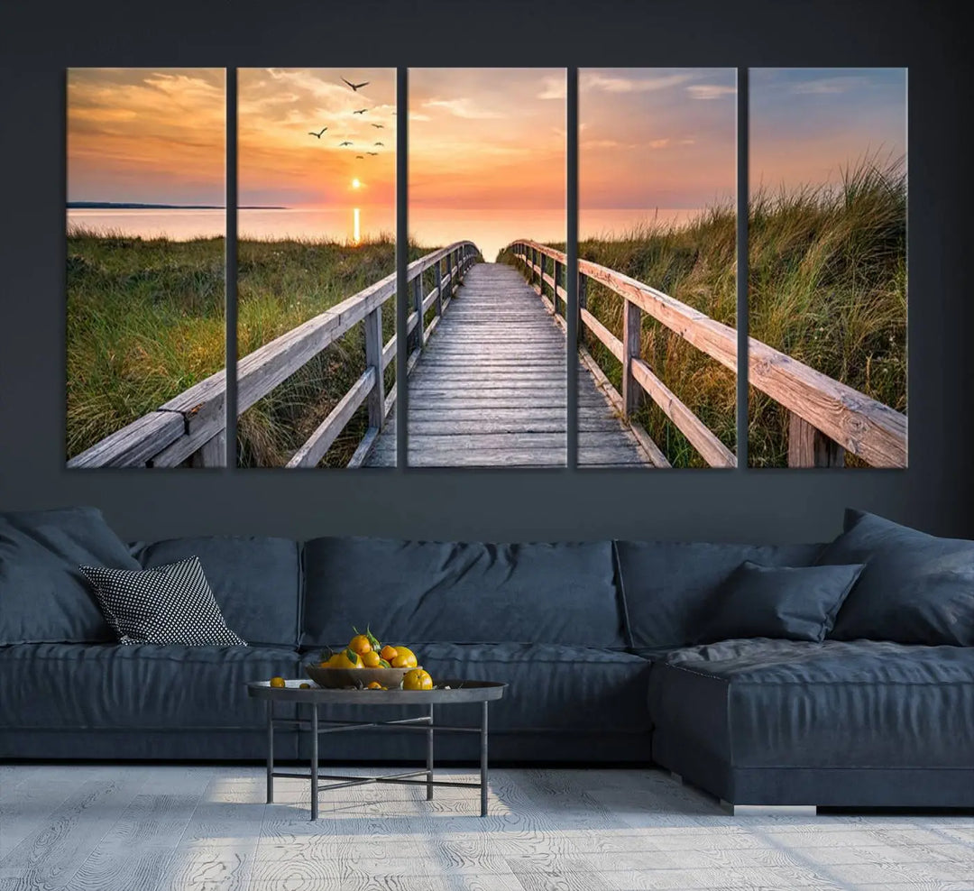 The Sunset Lakeside Pier Wall Art Canvas Print depicts a boardwalk leading towards a sunset over the ocean, framed by grassy dunes. Each piece is meticulously hand-assembled using museum-quality canvas to guarantee durability and vibrant colors.