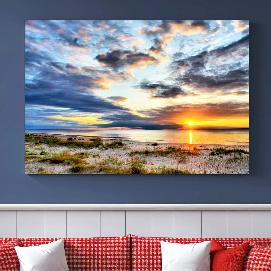 The living room features the Sunset On The Ocean Wall Art Canvas Print, a stunning large triptych depicting a sunset over a beach. This artwork is elegantly displayed on museum-quality canvas with UV-protective coating, ensuring both beauty and durability.