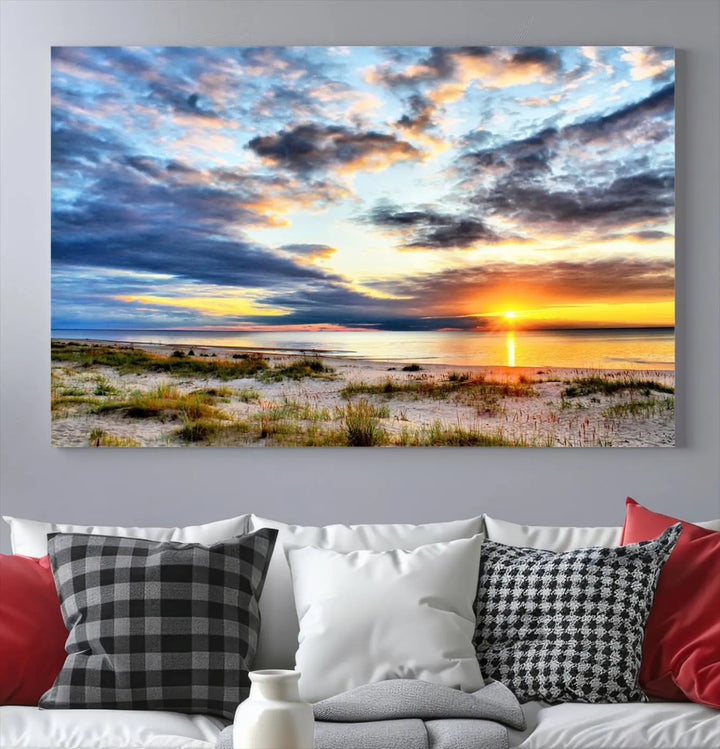 The living room features the Sunset On The Ocean Wall Art Canvas Print, a stunning large triptych depicting a sunset over a beach. This artwork is elegantly displayed on museum-quality canvas with UV-protective coating, ensuring both beauty and durability.