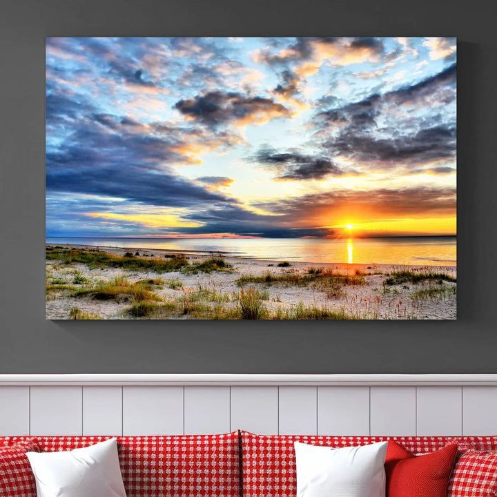 The living room features the Sunset On The Ocean Wall Art Canvas Print, a stunning large triptych depicting a sunset over a beach. This artwork is elegantly displayed on museum-quality canvas with UV-protective coating, ensuring both beauty and durability.