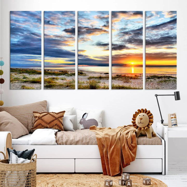 The living room features the Sunset On The Ocean Wall Art Canvas Print, a stunning large triptych depicting a sunset over a beach. This artwork is elegantly displayed on museum-quality canvas with UV-protective coating, ensuring both beauty and durability.