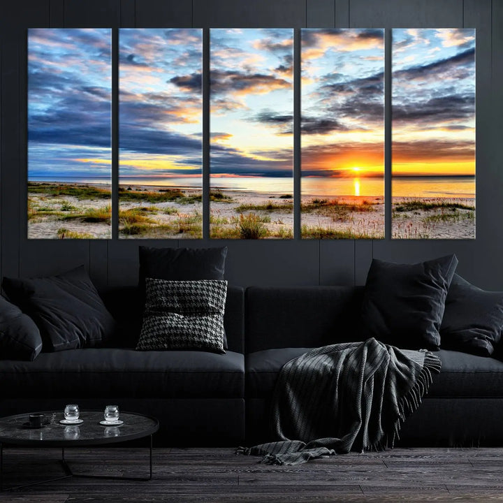 The living room features the Sunset On The Ocean Wall Art Canvas Print, a stunning large triptych depicting a sunset over a beach. This artwork is elegantly displayed on museum-quality canvas with UV-protective coating, ensuring both beauty and durability.