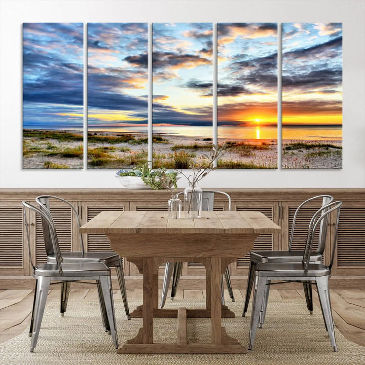 The living room features the Sunset On The Ocean Wall Art Canvas Print, a stunning large triptych depicting a sunset over a beach. This artwork is elegantly displayed on museum-quality canvas with UV-protective coating, ensuring both beauty and durability.