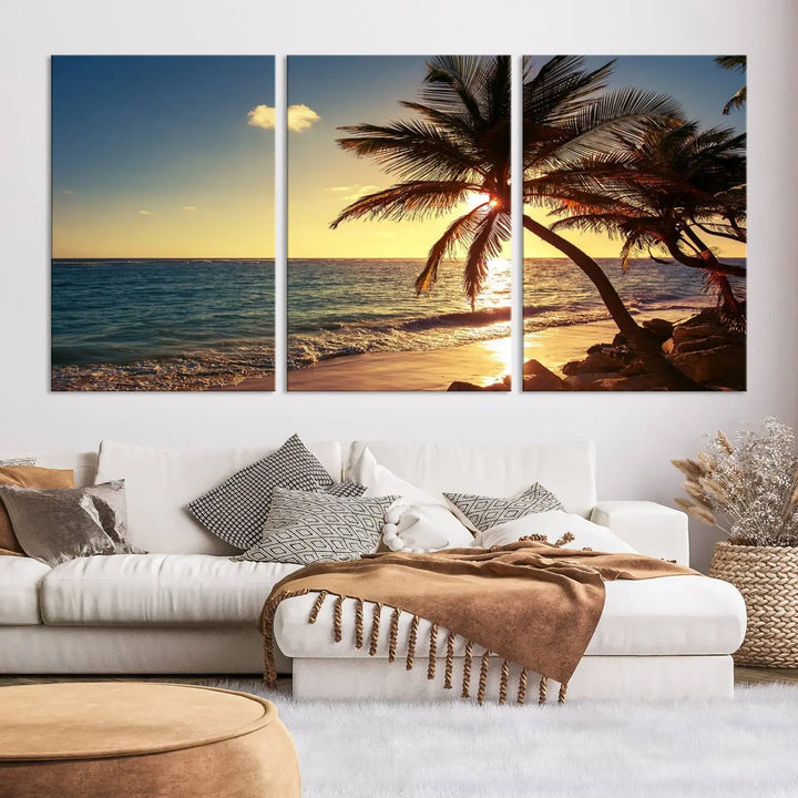 The Sunset Palm Trees Wall Art Canvas Print, a triptych masterpiece depicting a tropical beach sunset with palm trees, is expertly displayed on museum-quality canvases.