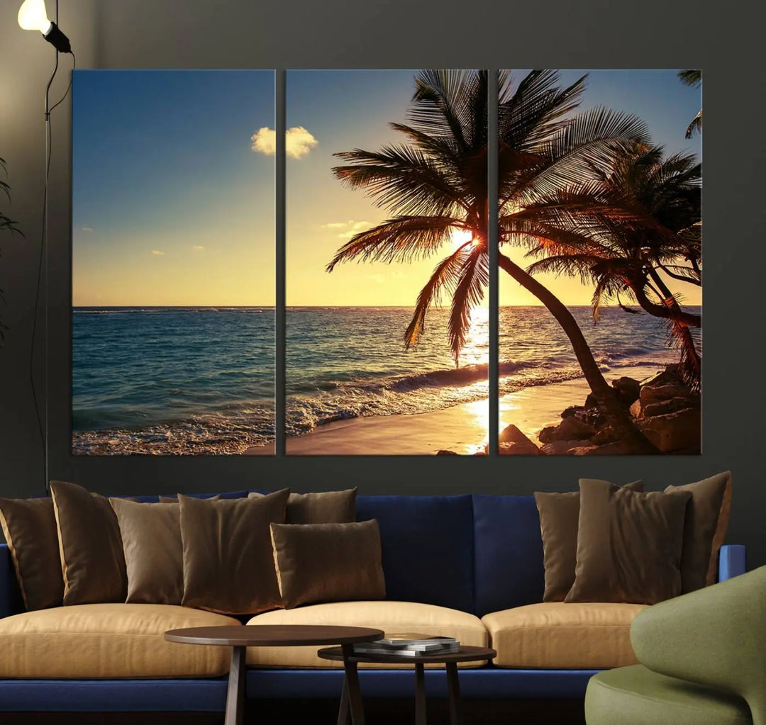 The Sunset Palm Trees Wall Art Canvas Print, a triptych masterpiece depicting a tropical beach sunset with palm trees, is expertly displayed on museum-quality canvases.