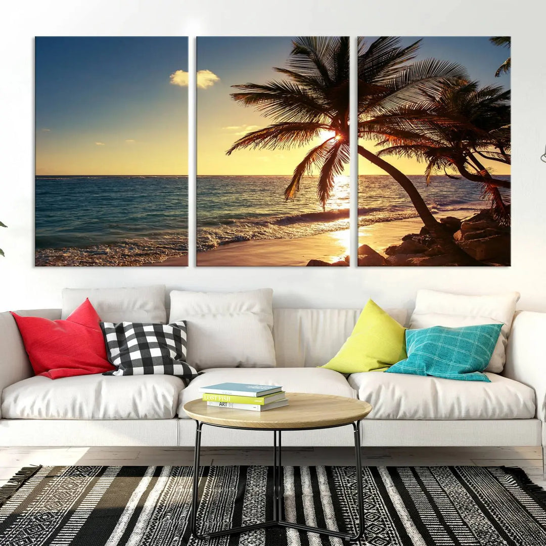 The Sunset Palm Trees Wall Art Canvas Print, a triptych masterpiece depicting a tropical beach sunset with palm trees, is expertly displayed on museum-quality canvases.