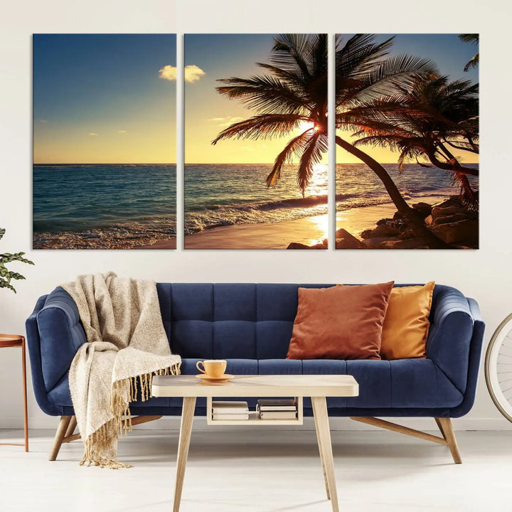 The Sunset Palm Trees Wall Art Canvas Print, a triptych masterpiece depicting a tropical beach sunset with palm trees, is expertly displayed on museum-quality canvases.