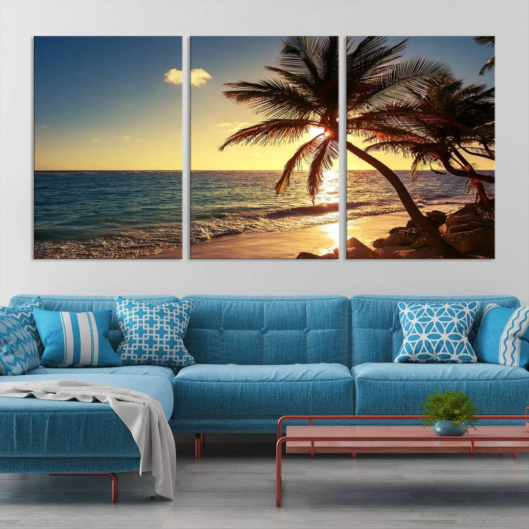 The Sunset Palm Trees Wall Art Canvas Print, a triptych masterpiece depicting a tropical beach sunset with palm trees, is expertly displayed on museum-quality canvases.