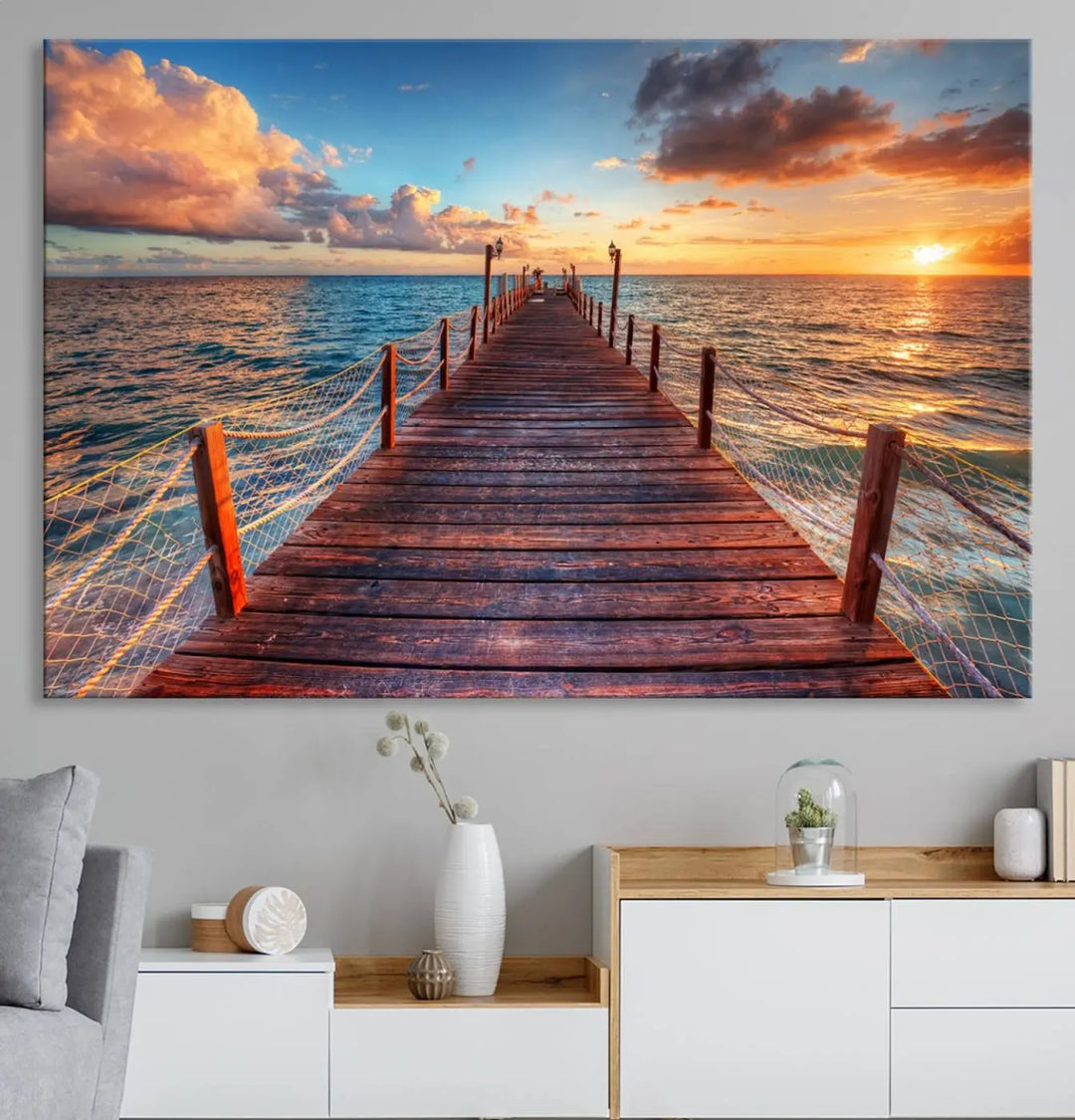 The Sunset Pier Canvas Wall Art is a triptych featuring an ocean landscape that elegantly captures a tranquil beach sunset with gentle ocean waves. It comes beautifully framed and ready to hang.