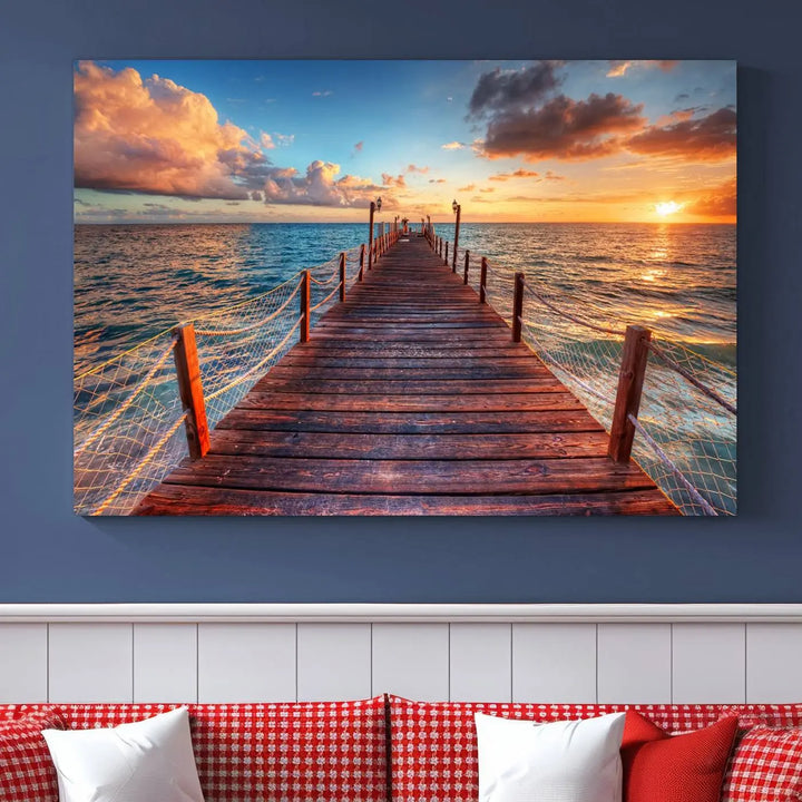 The Sunset Pier Canvas Wall Art is a triptych featuring an ocean landscape that elegantly captures a tranquil beach sunset with gentle ocean waves. It comes beautifully framed and ready to hang.