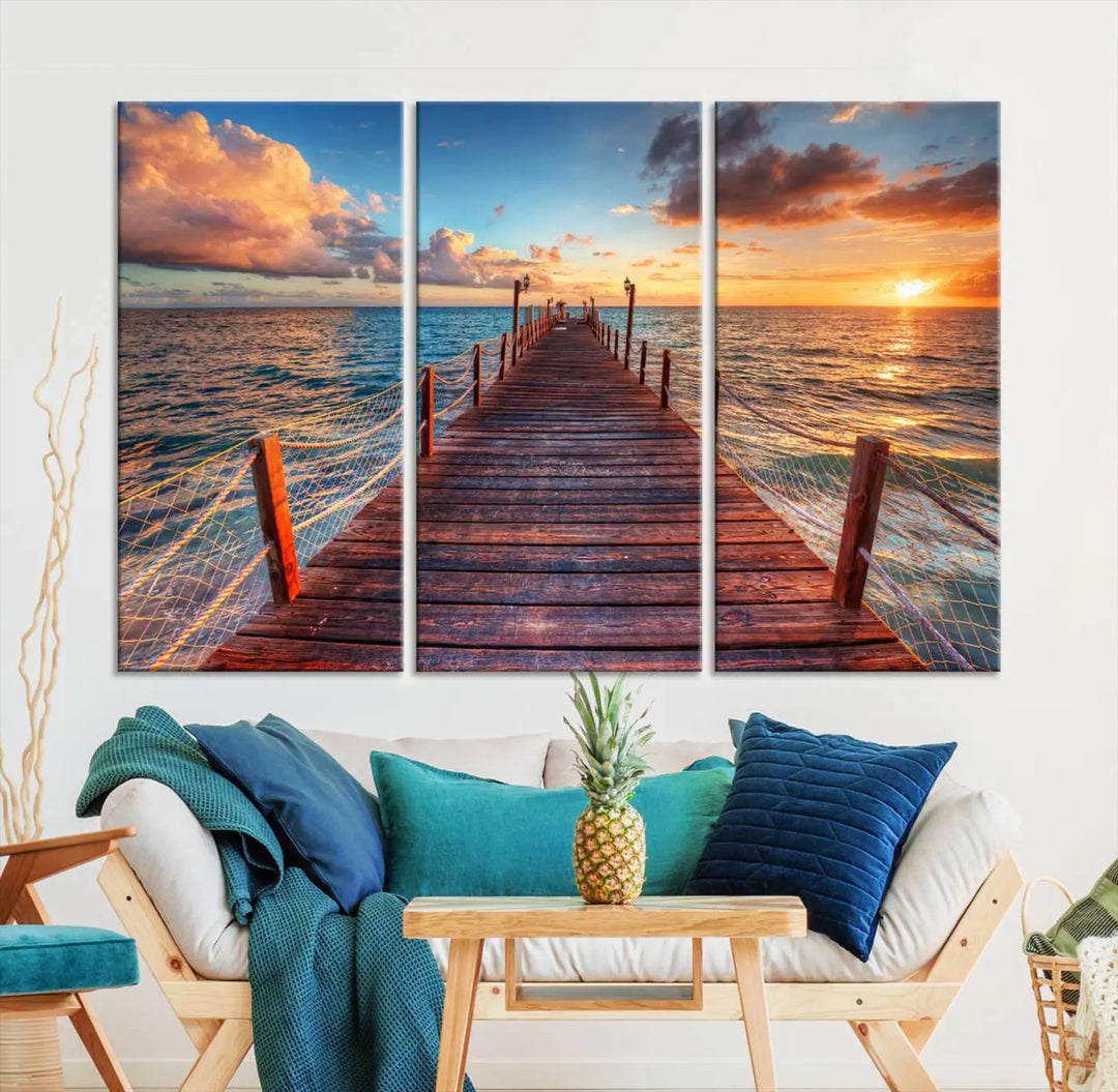 The Sunset Pier Canvas Wall Art is a triptych featuring an ocean landscape that elegantly captures a tranquil beach sunset with gentle ocean waves. It comes beautifully framed and ready to hang.