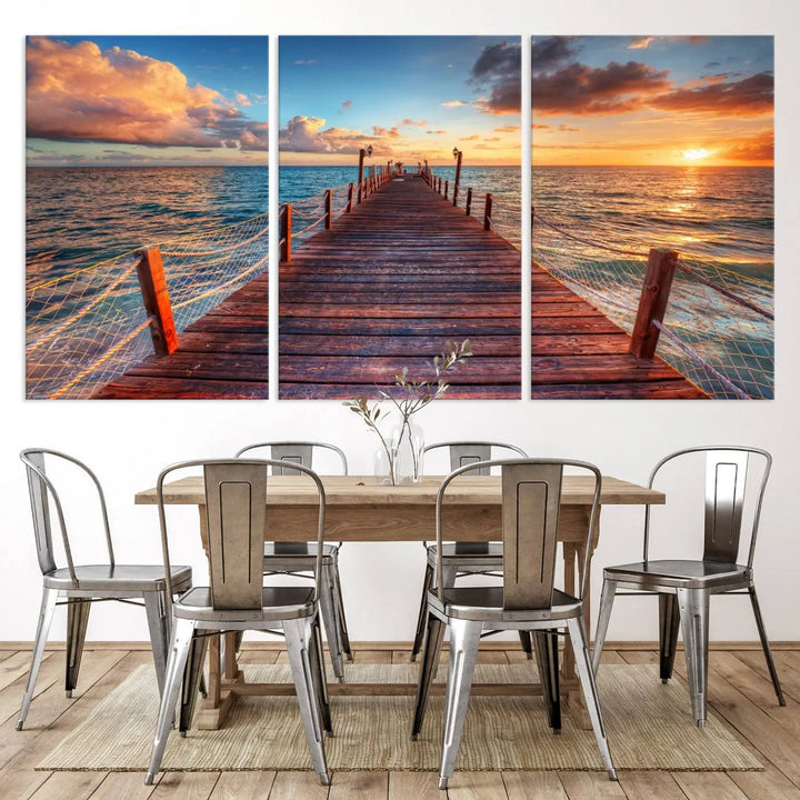 The Sunset Pier Canvas Wall Art is a triptych featuring an ocean landscape that elegantly captures a tranquil beach sunset with gentle ocean waves. It comes beautifully framed and ready to hang.