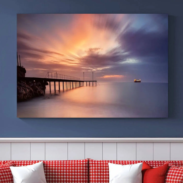 The Sunset Serenity Pier Canvas Art, a giclee canvas print with gallery wrap, beautifully captures a triptych of tranquility as the sun sets over calm waters. Featuring a pier on the left and a ship on the horizon, it adds an elegant touch to any living space with its serene coastal decor.