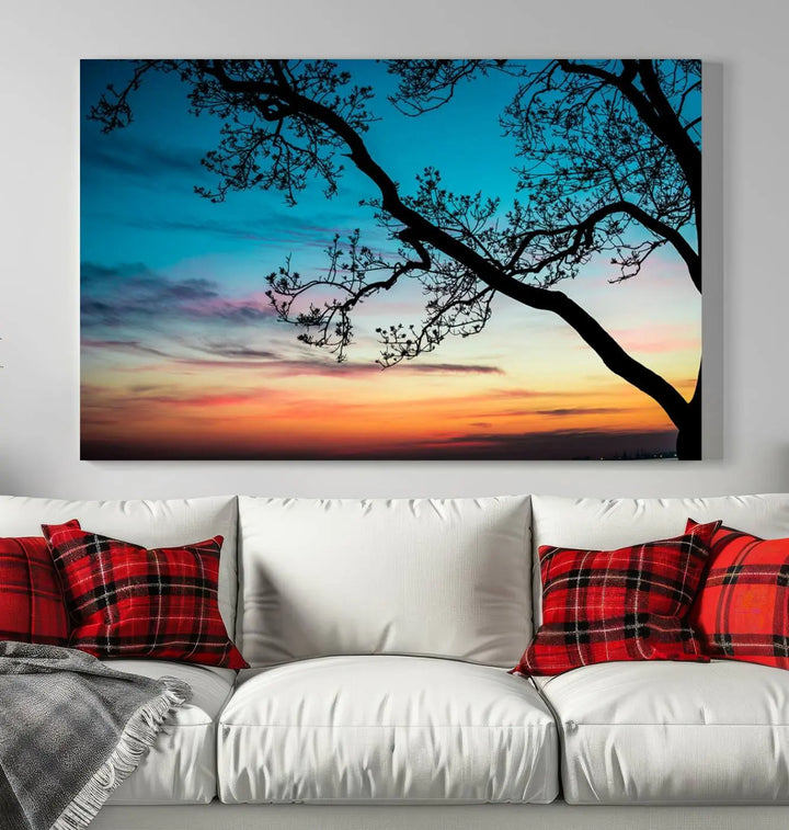 The "Sunset Tree Leaves Wall Art Canvas Print" features a triptych of tree branches against a vibrant sunset sky. Each piece is printed on museum-quality canvas and finished with a UV-protective coating, ensuring it is both stunning and ready to hang.