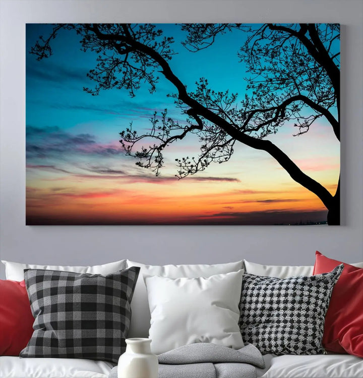 The "Sunset Tree Leaves Wall Art Canvas Print" features a triptych of tree branches against a vibrant sunset sky. Each piece is printed on museum-quality canvas and finished with a UV-protective coating, ensuring it is both stunning and ready to hang.